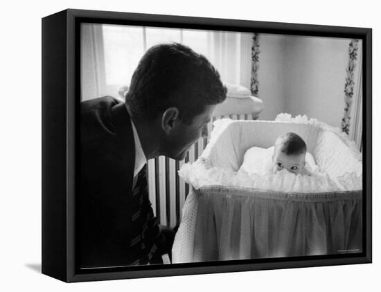 Sen. Jack Kennedy Admiring Baby Caroline as She Lies in Her Crib in Nursery at Georgetown Home-Ed Clark-Framed Premier Image Canvas