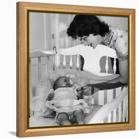 Sen. John Kennedy's Wife Jacqueline Offering Baby Caroline a Silver Rattle at their Georgetown Home-Nina Leen-Framed Premier Image Canvas