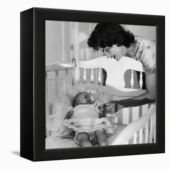 Sen. John Kennedy's Wife Jacqueline Offering Baby Caroline a Silver Rattle at their Georgetown Home-Nina Leen-Framed Premier Image Canvas