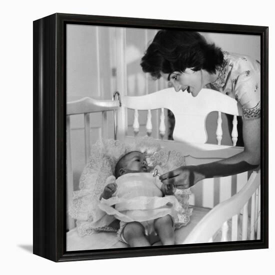 Sen. John Kennedy's Wife Jacqueline Offering Baby Caroline a Silver Rattle at their Georgetown Home-Nina Leen-Framed Premier Image Canvas