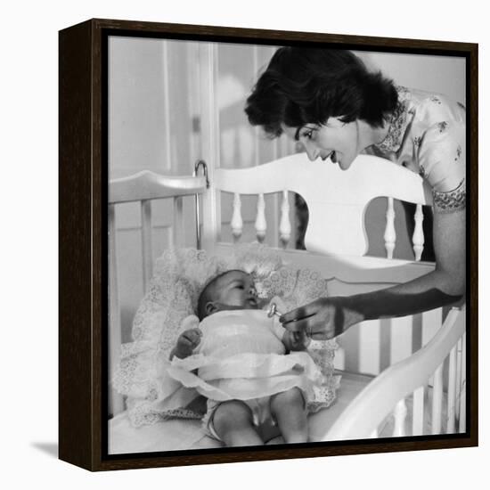 Sen. John Kennedy's Wife Jacqueline Offering Baby Caroline a Silver Rattle at their Georgetown Home-Nina Leen-Framed Premier Image Canvas