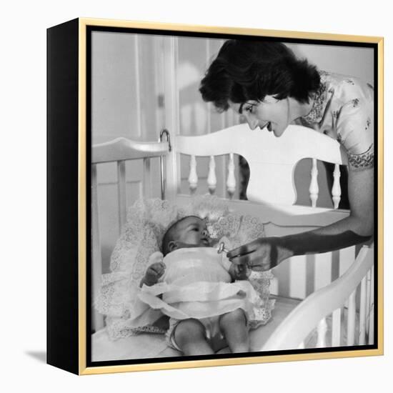 Sen. John Kennedy's Wife Jacqueline Offering Baby Caroline a Silver Rattle at their Georgetown Home-Nina Leen-Framed Premier Image Canvas