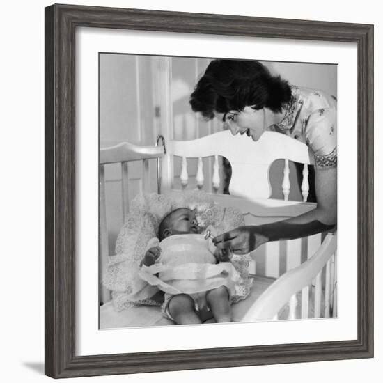 Sen. John Kennedy's Wife Jacqueline Offering Baby Caroline a Silver Rattle at their Georgetown Home-Nina Leen-Framed Premium Photographic Print