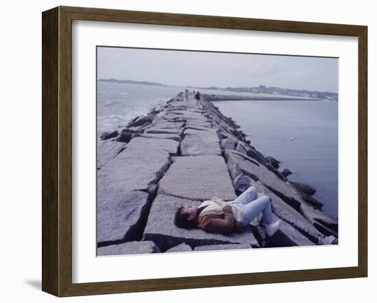 Senator Edward M. Kennedy Basking in Sun on Breakwater in Hyannis Port-John Loengard-Framed Photographic Print