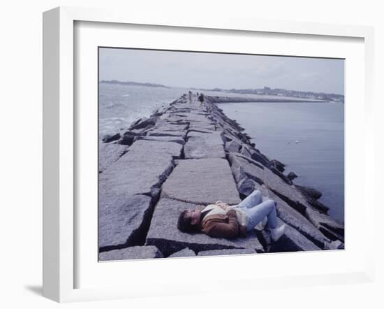 Senator Edward M. Kennedy Basking in Sun on Breakwater in Hyannis Port-John Loengard-Framed Photographic Print