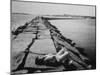 Senator Edward M. Kennedy Taking a Sunbath on Breakwater Near His Summer Home-John Loengard-Mounted Photographic Print