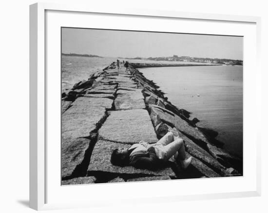 Senator Edward M. Kennedy Taking a Sunbath on Breakwater Near His Summer Home-John Loengard-Framed Photographic Print