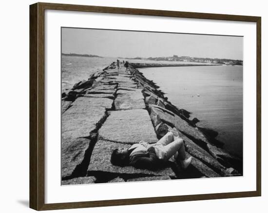 Senator Edward M. Kennedy Taking a Sunbath on Breakwater Near His Summer Home-John Loengard-Framed Photographic Print