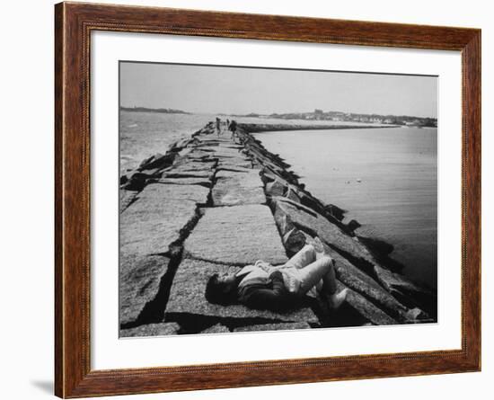 Senator Edward M. Kennedy Taking a Sunbath on Breakwater Near His Summer Home-John Loengard-Framed Photographic Print