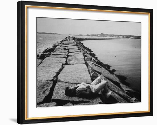 Senator Edward M. Kennedy Taking a Sunbath on Breakwater Near His Summer Home-John Loengard-Framed Photographic Print
