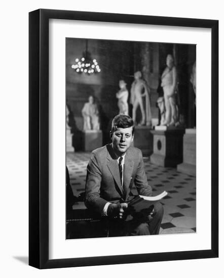 Senator John F. Kennedy Seated in Museum with Statues-Hank Walker-Framed Photographic Print
