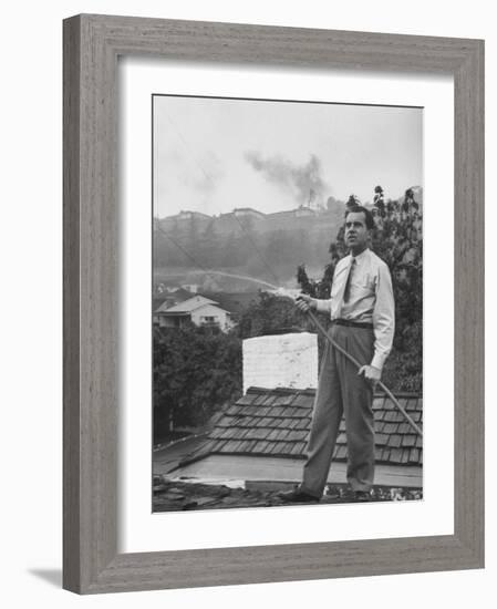 Senator Richard M. Nixon on Roof of Home in Los Angeles, Putting Out Fires Caused by Brush Blaze-Allan Grant-Framed Photographic Print