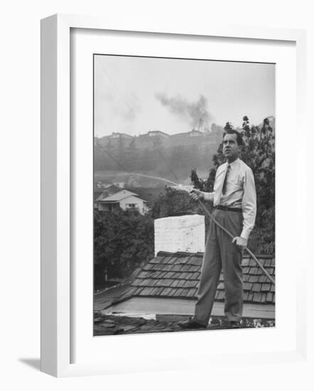 Senator Richard M. Nixon on Roof of Home in Los Angeles, Putting Out Fires Caused by Brush Blaze-Allan Grant-Framed Photographic Print