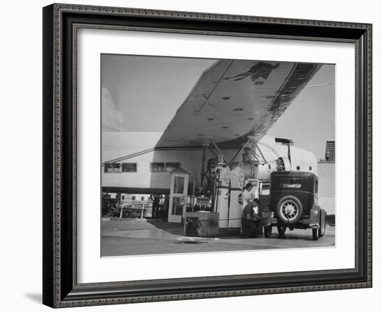 Service Attendant Pumping Gasoline Into Ford Sedan as Woman Watches at Gas Pumps-Peter Stackpole-Framed Photographic Print