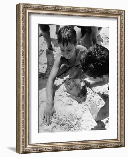 Settlement House Children Burying Boy under Sand at the Beach-Martha Holmes-Framed Photographic Print