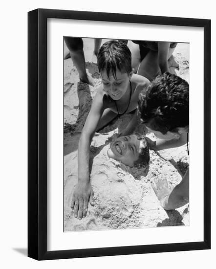 Settlement House Children Burying Boy under Sand at the Beach-Martha Holmes-Framed Photographic Print