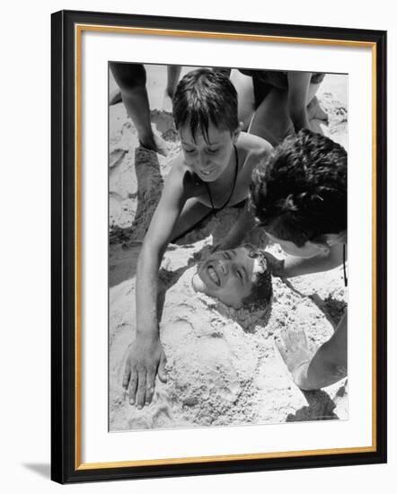 Settlement House Children Burying Boy under Sand at the Beach-Martha Holmes-Framed Photographic Print