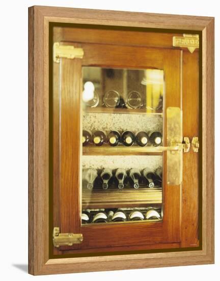 Several Wine Bottles in Wood-Panelled Drinks Cabinet-Peter Medilek-Framed Premier Image Canvas