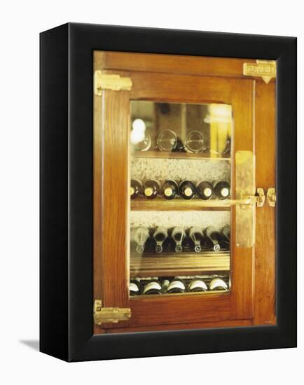 Several Wine Bottles in Wood-Panelled Drinks Cabinet-Peter Medilek-Framed Premier Image Canvas