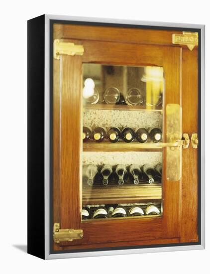 Several Wine Bottles in Wood-Panelled Drinks Cabinet-Peter Medilek-Framed Premier Image Canvas