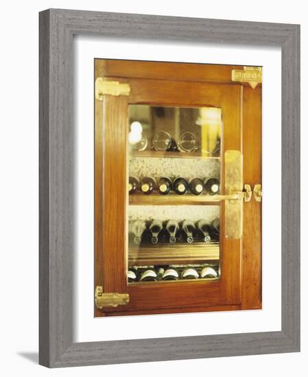 Several Wine Bottles in Wood-Panelled Drinks Cabinet-Peter Medilek-Framed Photographic Print