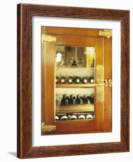 Several Wine Bottles in Wood-Panelled Drinks Cabinet-Peter Medilek-Framed Photographic Print