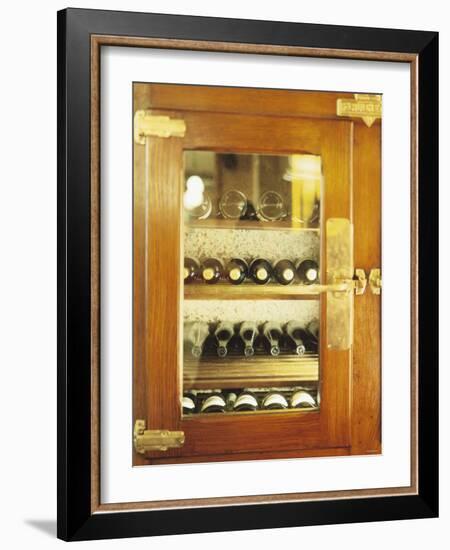 Several Wine Bottles in Wood-Panelled Drinks Cabinet-Peter Medilek-Framed Photographic Print