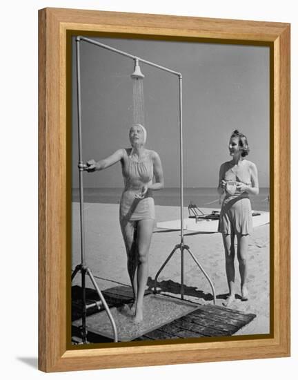 Shapely Sunbather Taking an Outdoor Shower as Woman Preparing for Her Turn, Looks On, at Beach-Alfred Eisenstaedt-Framed Premier Image Canvas