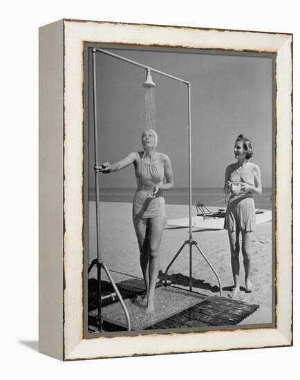 Shapely Sunbather Taking an Outdoor Shower as Woman Preparing for Her Turn, Looks On, at Beach-Alfred Eisenstaedt-Framed Premier Image Canvas