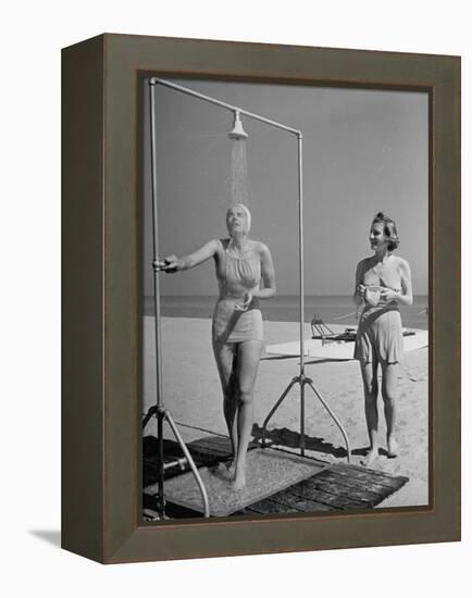 Shapely Sunbather Taking an Outdoor Shower as Woman Preparing for Her Turn, Looks On, at Beach-Alfred Eisenstaedt-Framed Premier Image Canvas