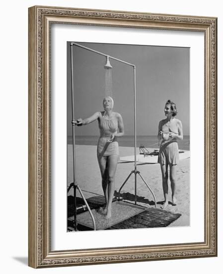 Shapely Sunbather Taking an Outdoor Shower as Woman Preparing for Her Turn, Looks On, at Beach-Alfred Eisenstaedt-Framed Photographic Print