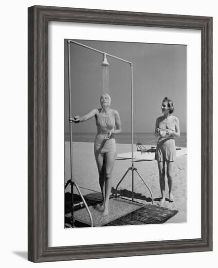 Shapely Sunbather Taking an Outdoor Shower as Woman Preparing for Her Turn, Looks On, at Beach-Alfred Eisenstaedt-Framed Photographic Print