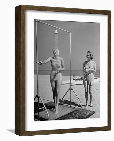 Shapely Sunbather Taking an Outdoor Shower as Woman Preparing for Her Turn, Looks On, at Beach-Alfred Eisenstaedt-Framed Photographic Print