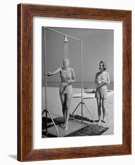 Shapely Sunbather Taking an Outdoor Shower as Woman Preparing for Her Turn, Looks On, at Beach-Alfred Eisenstaedt-Framed Photographic Print