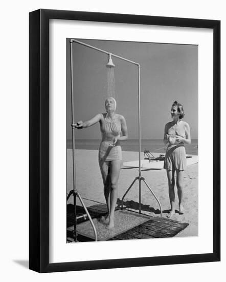Shapely Sunbather Taking an Outdoor Shower as Woman Preparing for Her Turn, Looks On, at Beach-Alfred Eisenstaedt-Framed Photographic Print