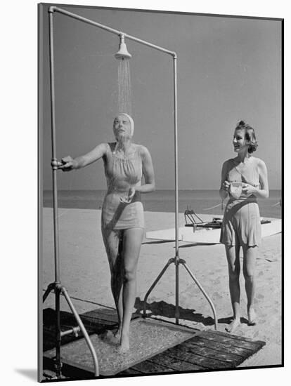 Shapely Sunbather Taking an Outdoor Shower as Woman Preparing for Her Turn, Looks On, at Beach-Alfred Eisenstaedt-Mounted Photographic Print