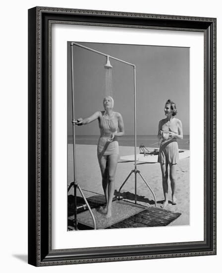 Shapely Sunbather Taking an Outdoor Shower as Woman Preparing for Her Turn, Looks On, at Beach-Alfred Eisenstaedt-Framed Photographic Print