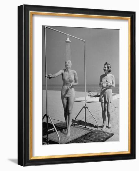 Shapely Sunbather Taking an Outdoor Shower as Woman Preparing for Her Turn, Looks On, at Beach-Alfred Eisenstaedt-Framed Photographic Print