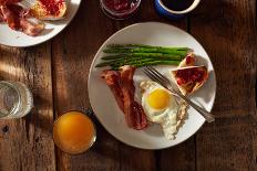 Bacon, A Sunny Side Up Egg, Pan Grilled Asparagus And Toast With Raspberry Jam On Wooden Farmtable-Shea Evans-Photographic Print