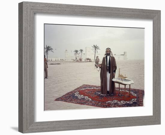 Sheik Shakbut Bin Sultan Al Nahyan Standing in Front of His Palace Holding a Falcon, 1963-Ralph Crane-Framed Photographic Print