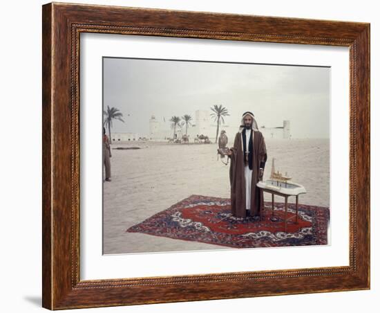 Sheik Shakbut Bin Sultan Al Nahyan Standing in Front of His Palace Holding a Falcon, 1963-Ralph Crane-Framed Photographic Print