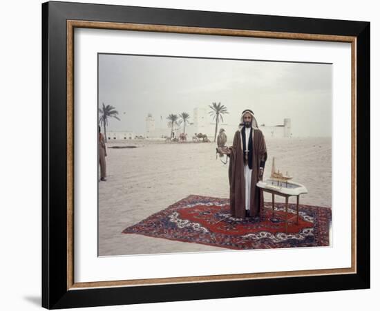 Sheik Shakbut Bin Sultan Al Nahyan Standing in Front of His Palace Holding a Falcon, 1963-Ralph Crane-Framed Photographic Print