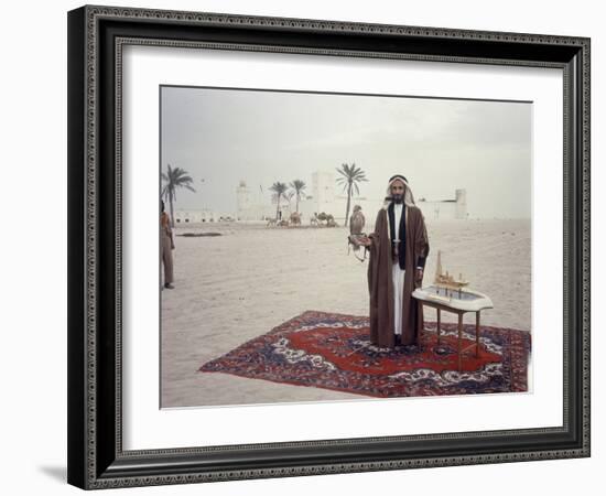 Sheik Shakbut Bin Sultan Al Nahyan Standing in Front of His Palace Holding a Falcon, 1963-Ralph Crane-Framed Photographic Print