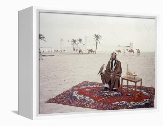 Sheikh Shakhbut Bin Sultan Al Nahyan Sitting in Front of His Palace Holding a Falcon, 1963-Ralph Crane-Framed Premier Image Canvas