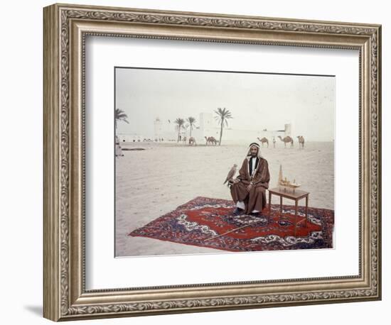 Sheikh Shakhbut Bin Sultan Al Nahyan Sitting in Front of His Palace Holding a Falcon, 1963-Ralph Crane-Framed Photographic Print