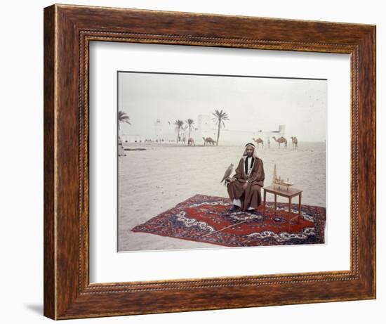 Sheikh Shakhbut Bin Sultan Al Nahyan Sitting in Front of His Palace Holding a Falcon, 1963-Ralph Crane-Framed Photographic Print