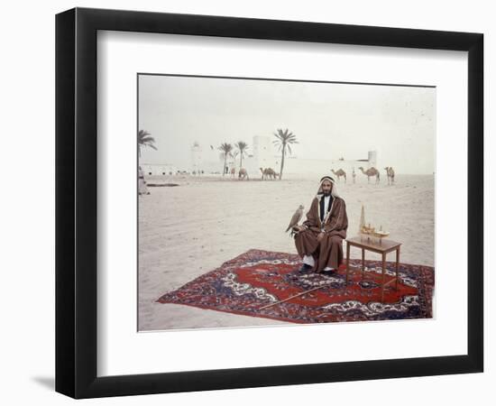 Sheikh Shakhbut Bin Sultan Al Nahyan Sitting in Front of His Palace Holding a Falcon, 1963-Ralph Crane-Framed Photographic Print
