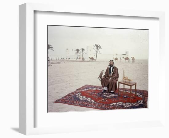 Sheikh Shakhbut Bin Sultan Al Nahyan Sitting in Front of His Palace Holding a Falcon, 1963-Ralph Crane-Framed Photographic Print