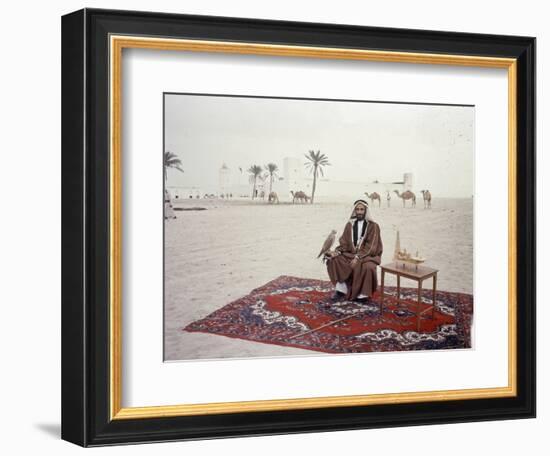 Sheikh Shakhbut Bin Sultan Al Nahyan Sitting in Front of His Palace Holding a Falcon, 1963-Ralph Crane-Framed Photographic Print