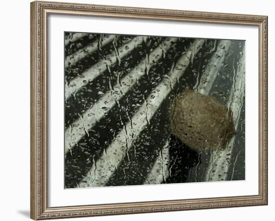 Sheltering Under an Umbrella as He Walks Along a Street During a Rain Storm in Central Athens-null-Framed Photographic Print